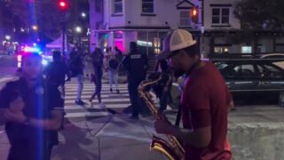 Wild Street Fight Ends with Cops Using Tasers and a Sax Man Playing Tunes